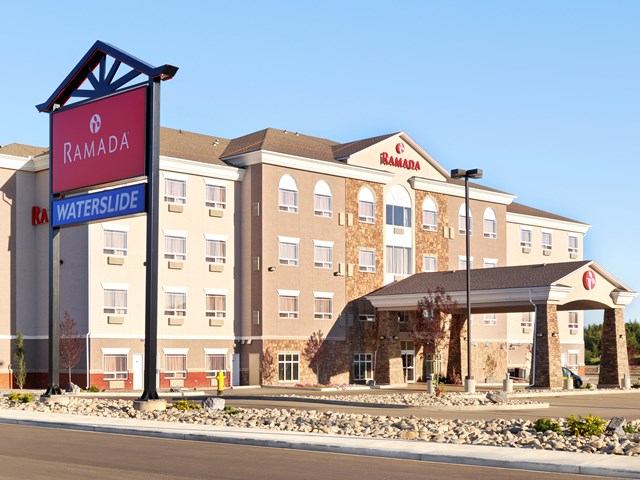 Exterior of Ramada Lac La Biche with waterslide sign and covered entrance.