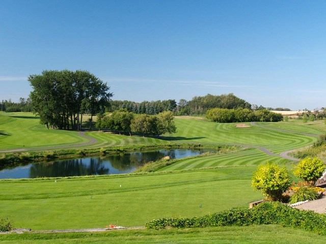Golf course fairway with pond and trees at The Ranch Golf and Country Club.