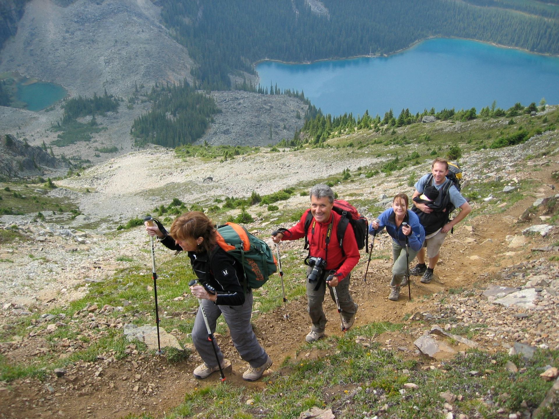 A group of people climbing to the pass