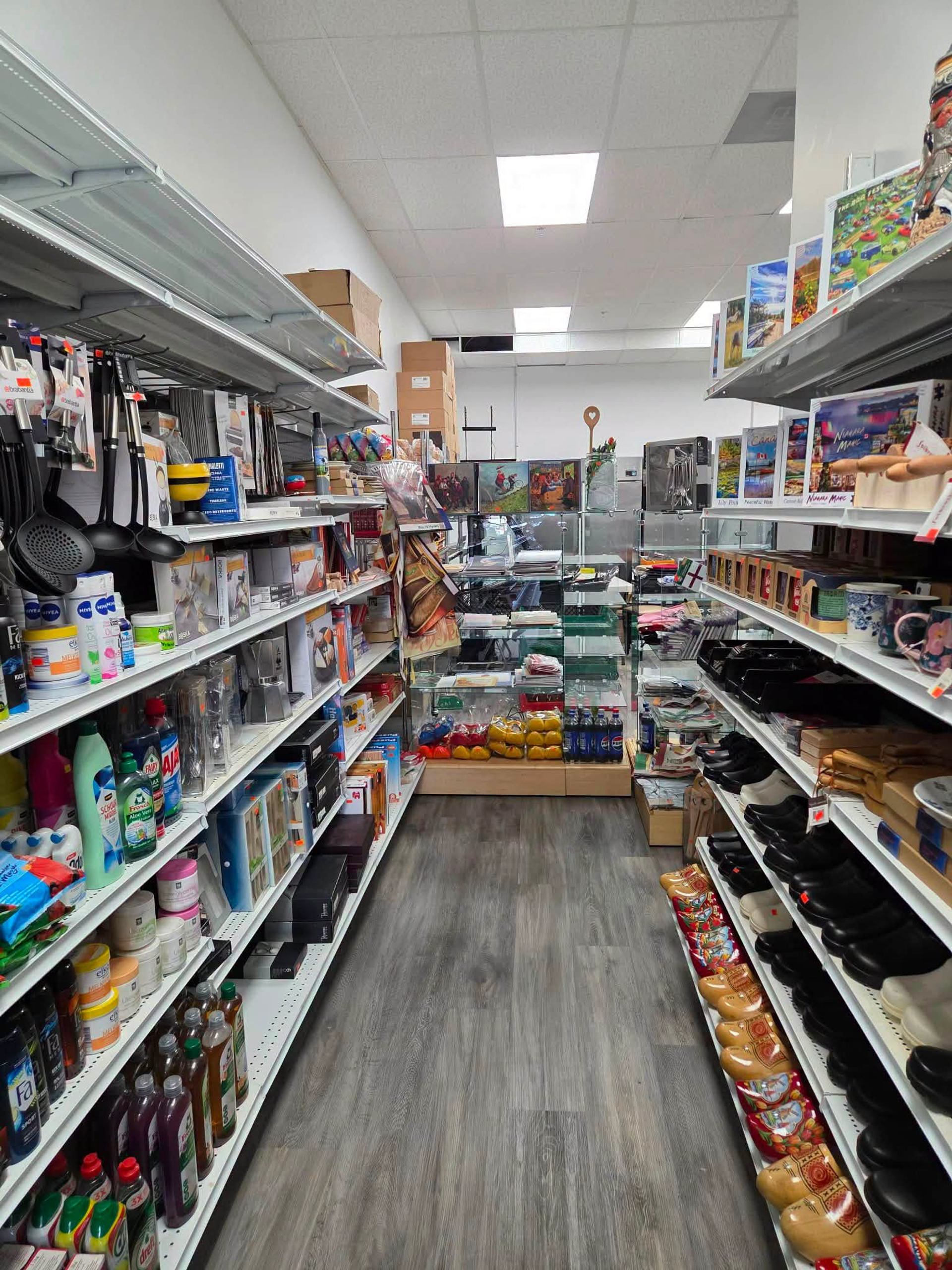 Store aisles display kitchenware, specialty foods, souvenirs, and traditional wooden clogs.