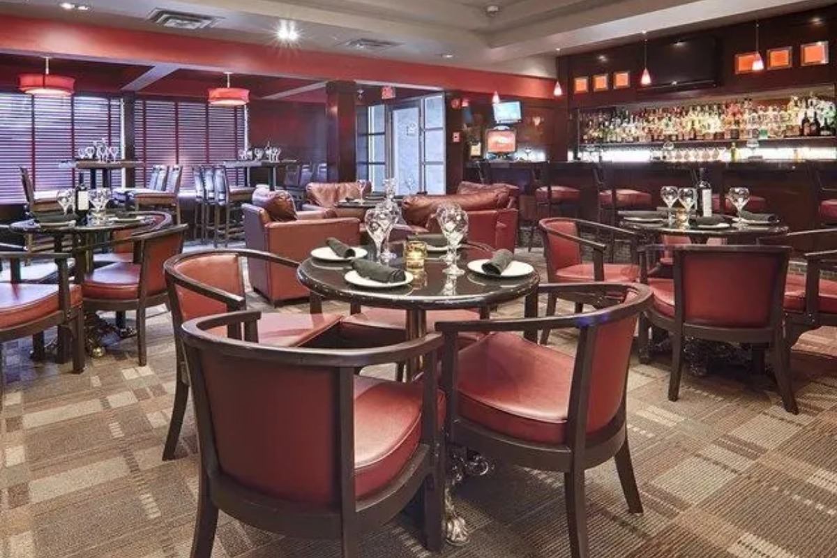 Restaurant on site with red chairs and tables.