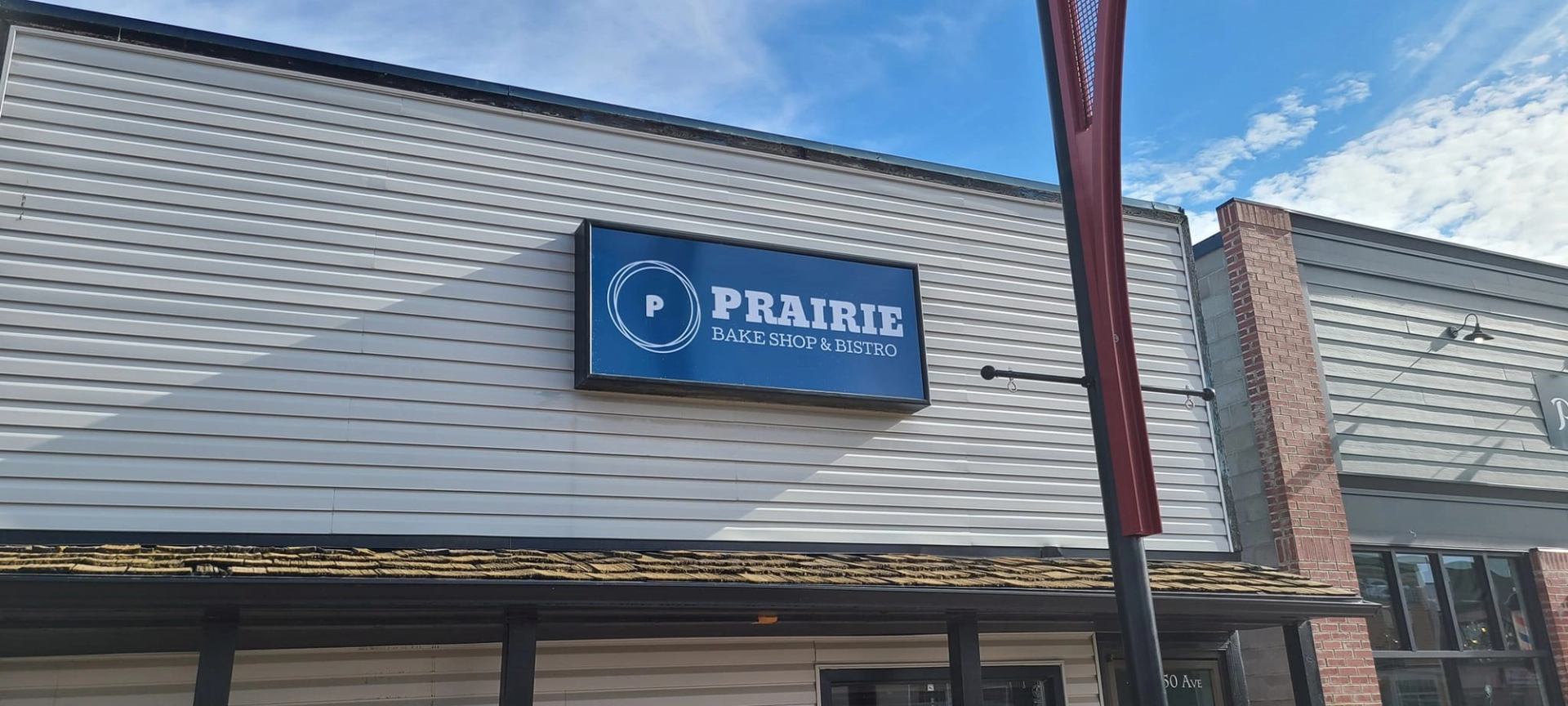 Prairie Bake Shop & Bistro storefront sign on a light-gray building facade.
