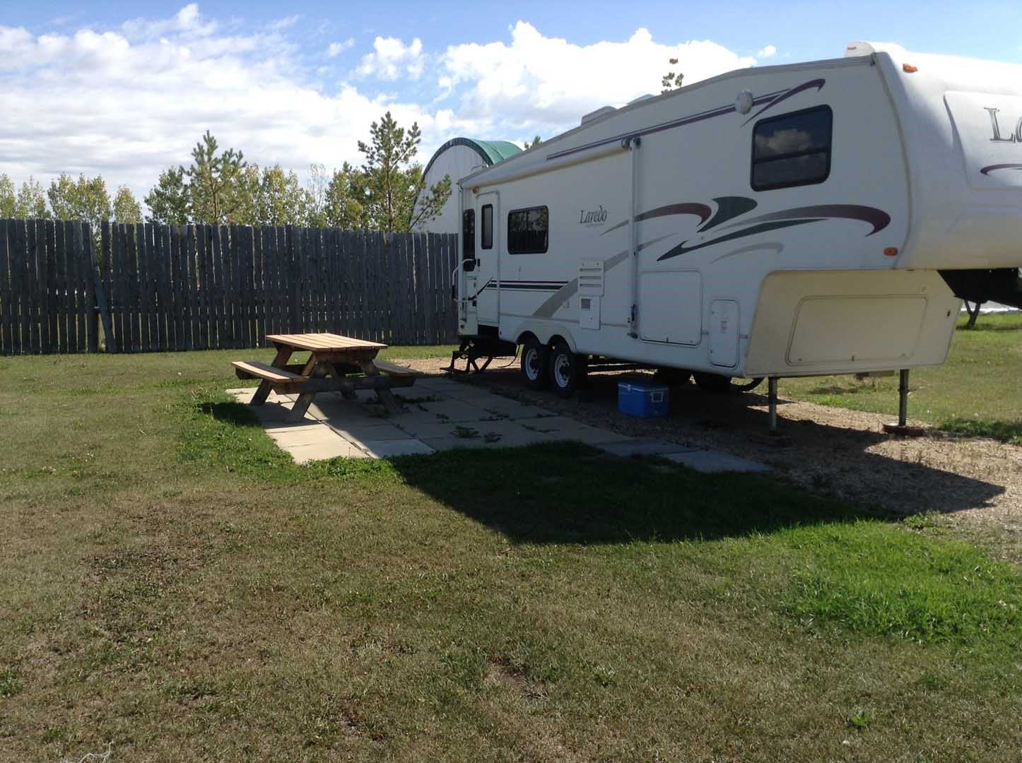 Nice spacous campsite with an RV and picnic table.