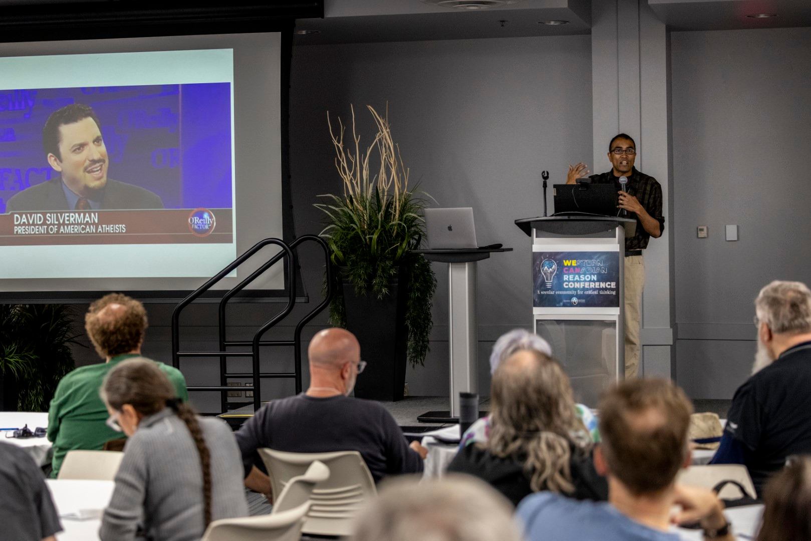 A guest speaker speeding to a room full of people.