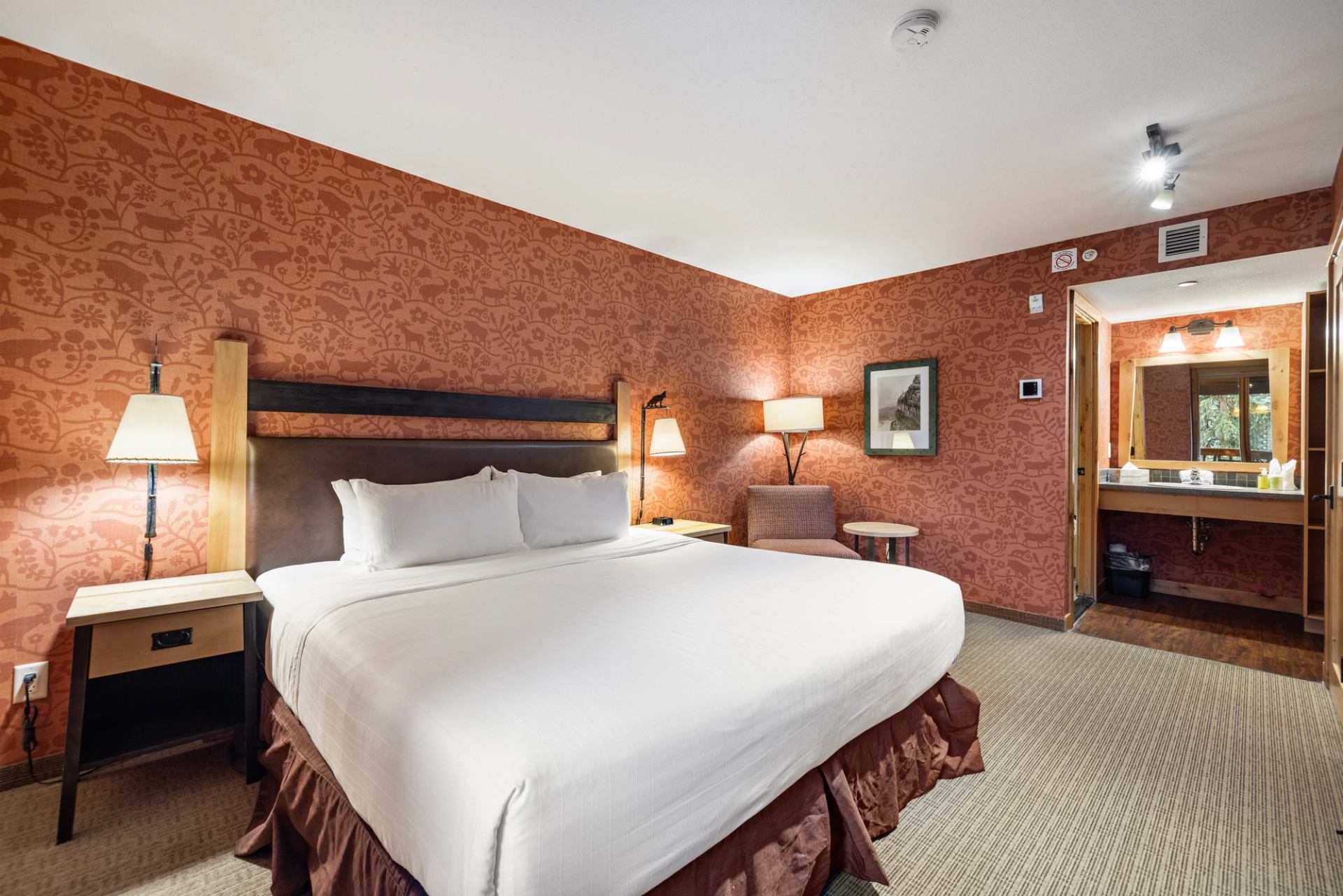 Cozy Fox Hotel room with large bed, red wallpaper, and ensuite bathroom.
