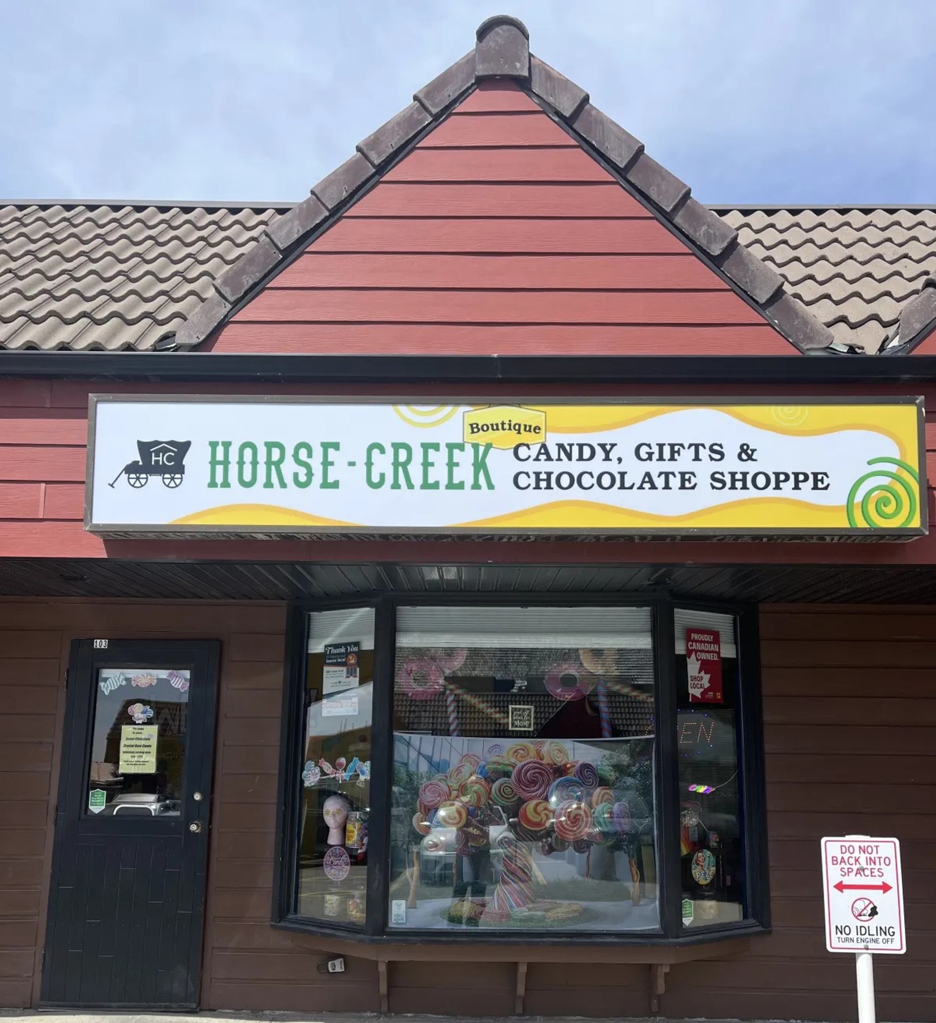 Storefront of Horse Creek Candy, Gifts & Chocolate Shoppe with lollipop display window.
