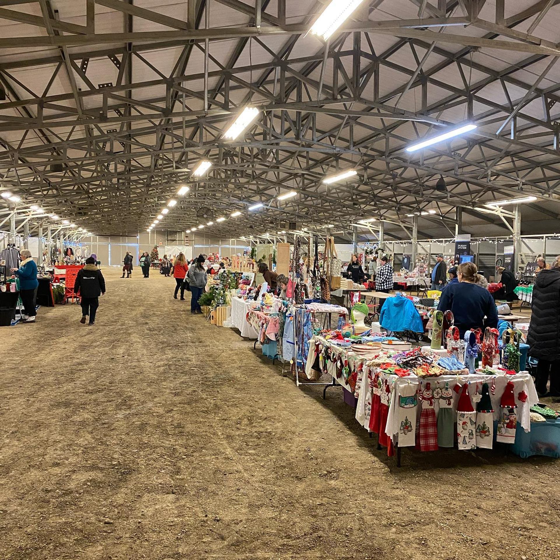 A long row of decorated vendor booths at a holiday market