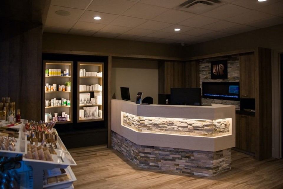 Day spa reception area with counter, shelves of skincare products, and display table.