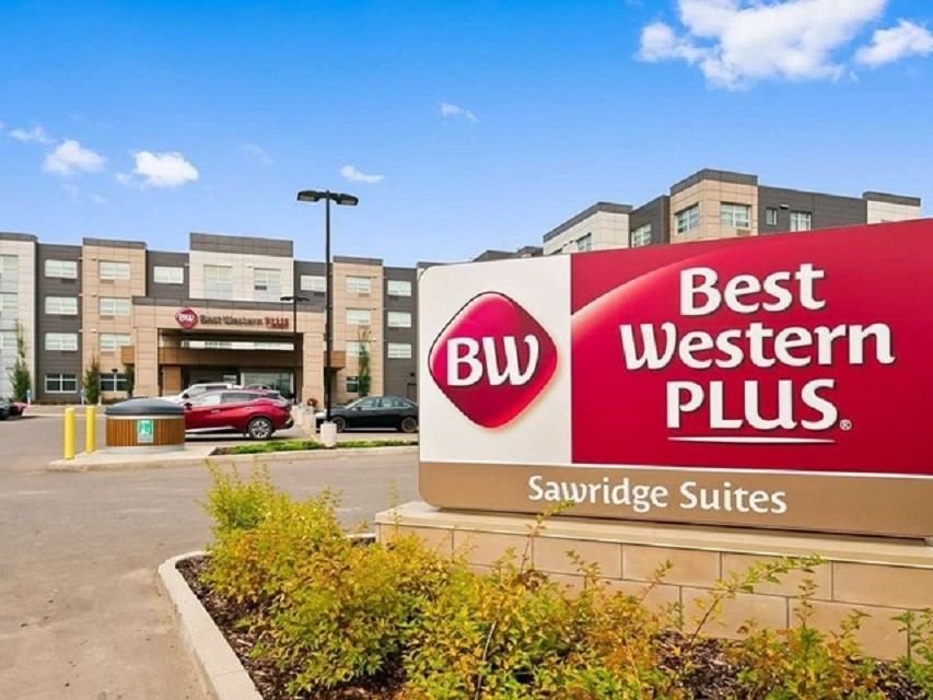 Best Western Plus exterior with sign and modern building in background.