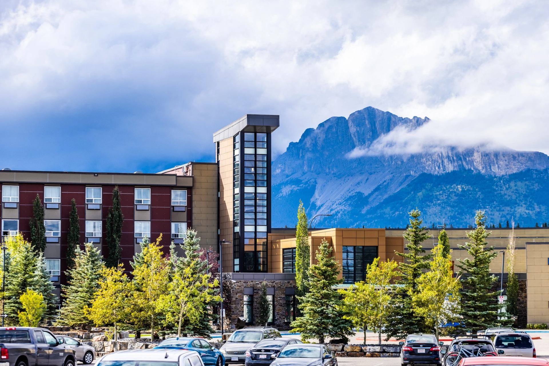 Stoney Nakoda Resort under cloudy sky.