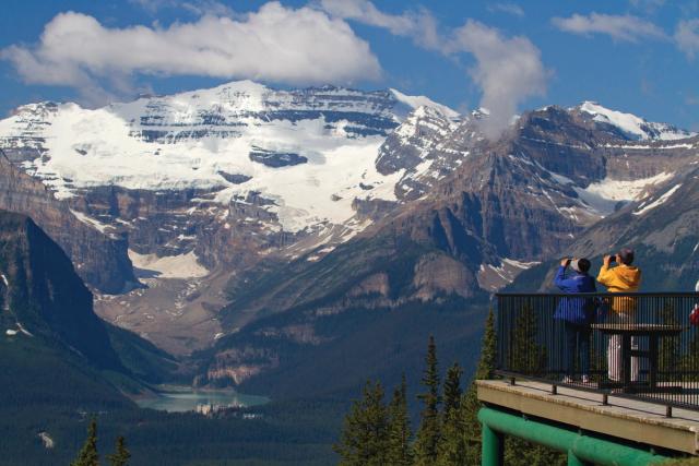 Couple looking at the view of the glacier above Lake Louise in Banff National Park.