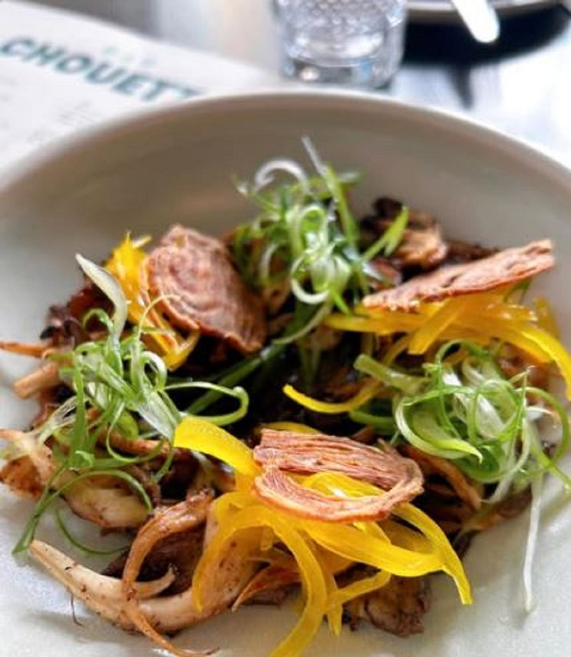 A plate of Grilled Oyster Mushrooms with black garlic, pickled onions and miso at Bar Chouette. 