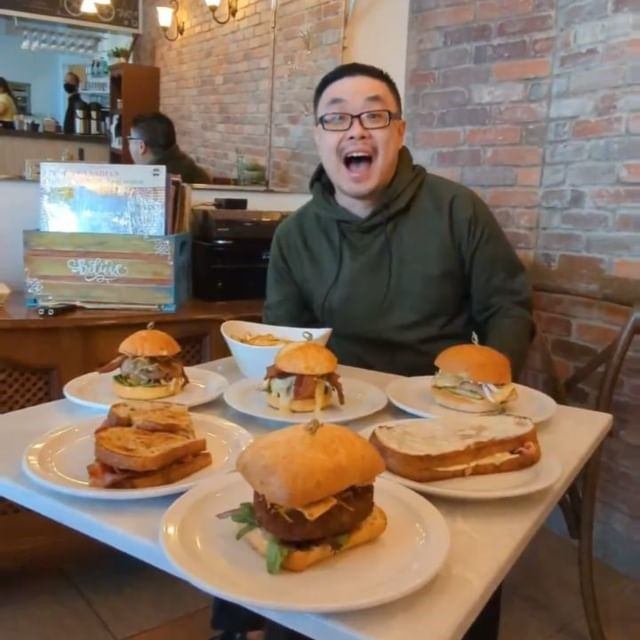 Assorted burgers and sandwiches on a table at Cafe Bicyclette.