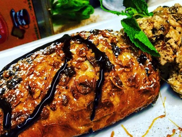 Glazed pastry and scone garnished with mint at Our Flames Restaurant & Lounge.