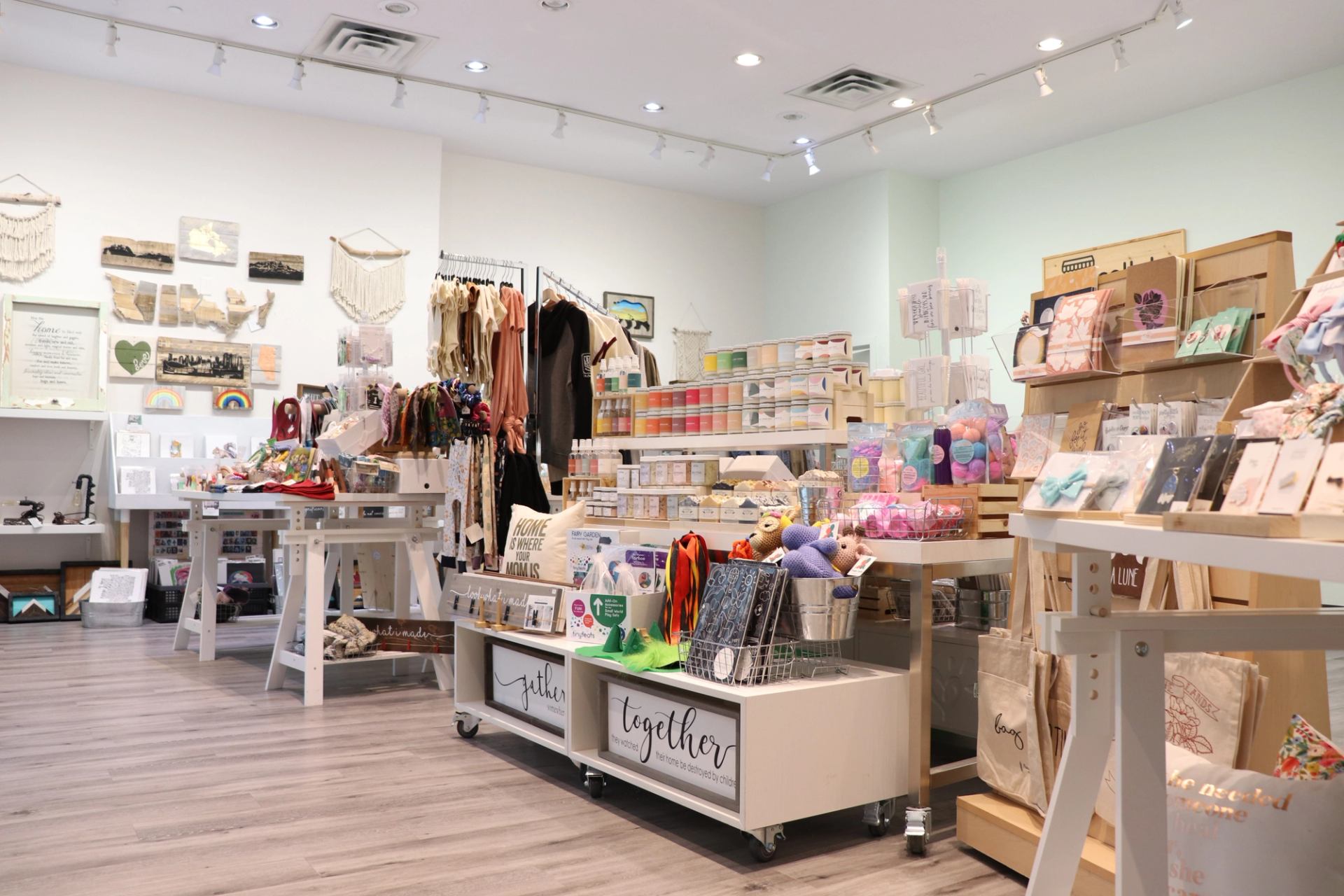 Bright retail store interior with jewelry, stationery, and decorative items on display.