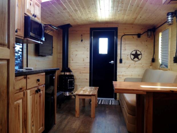 Interior kitchen and living area in an Aspen Crossing Caboose Cabins.