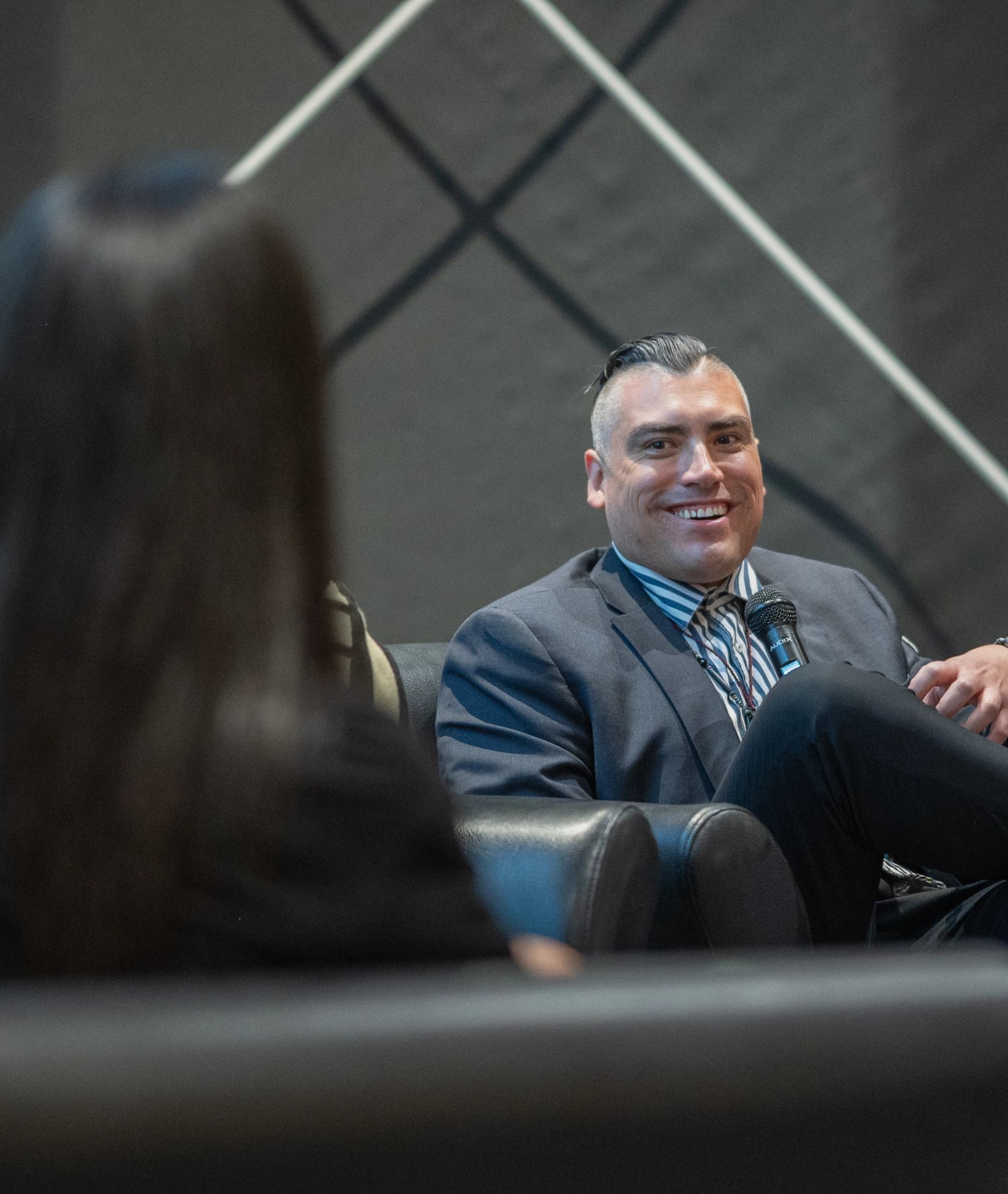 Man smiles during panel discussion