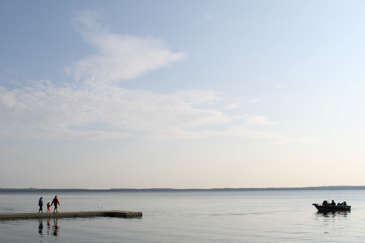 Two people stood on a dock in Pigeon Lake