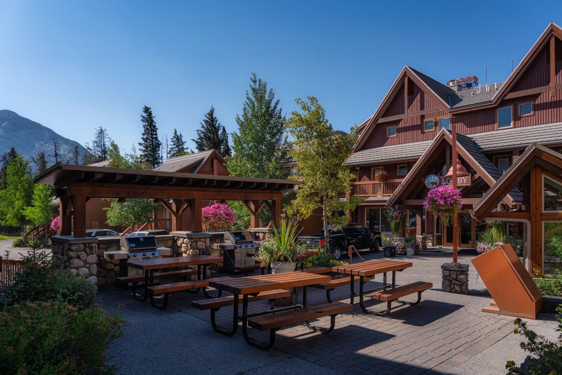 Picnic area with tables, bbqs, and lots of flowers surrounding