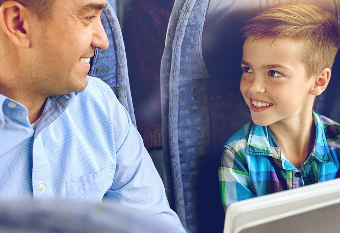 Father and son enjoying trip on Cold Shot bus.