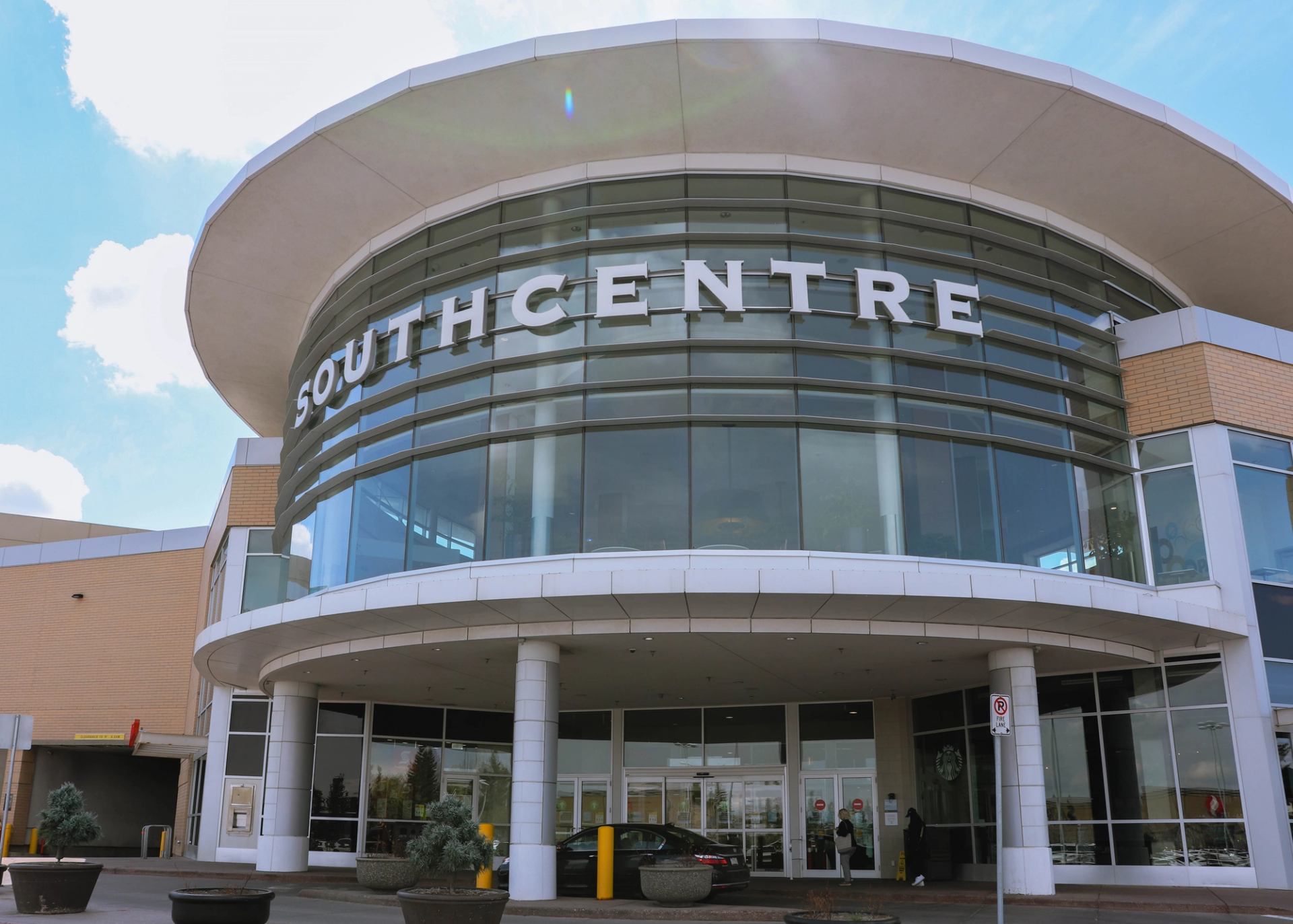 Southcentre Mall entrance with curved glass facade and bold signage.