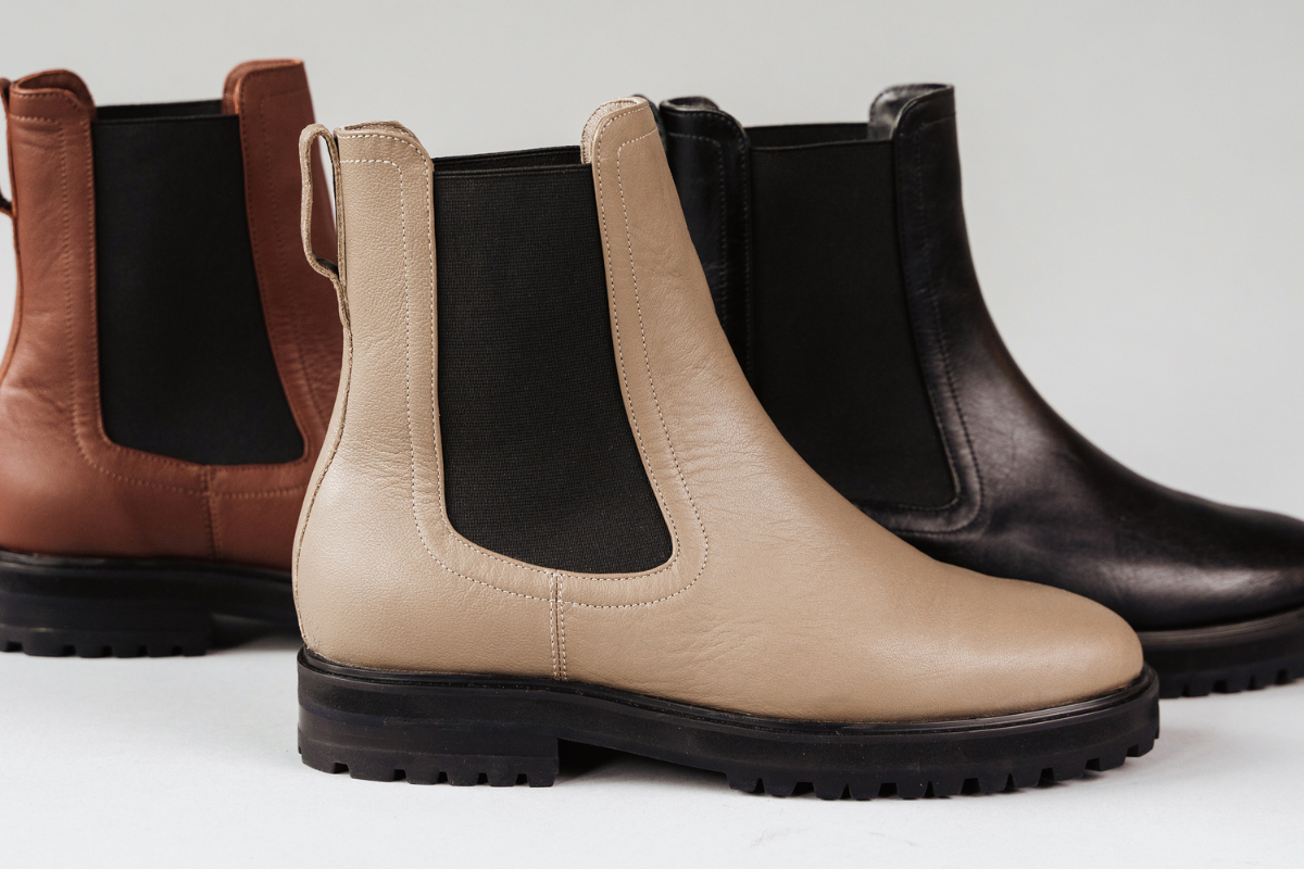Trio of Chelsea boots in beige, black, and brown with rugged soles and elastic panels.