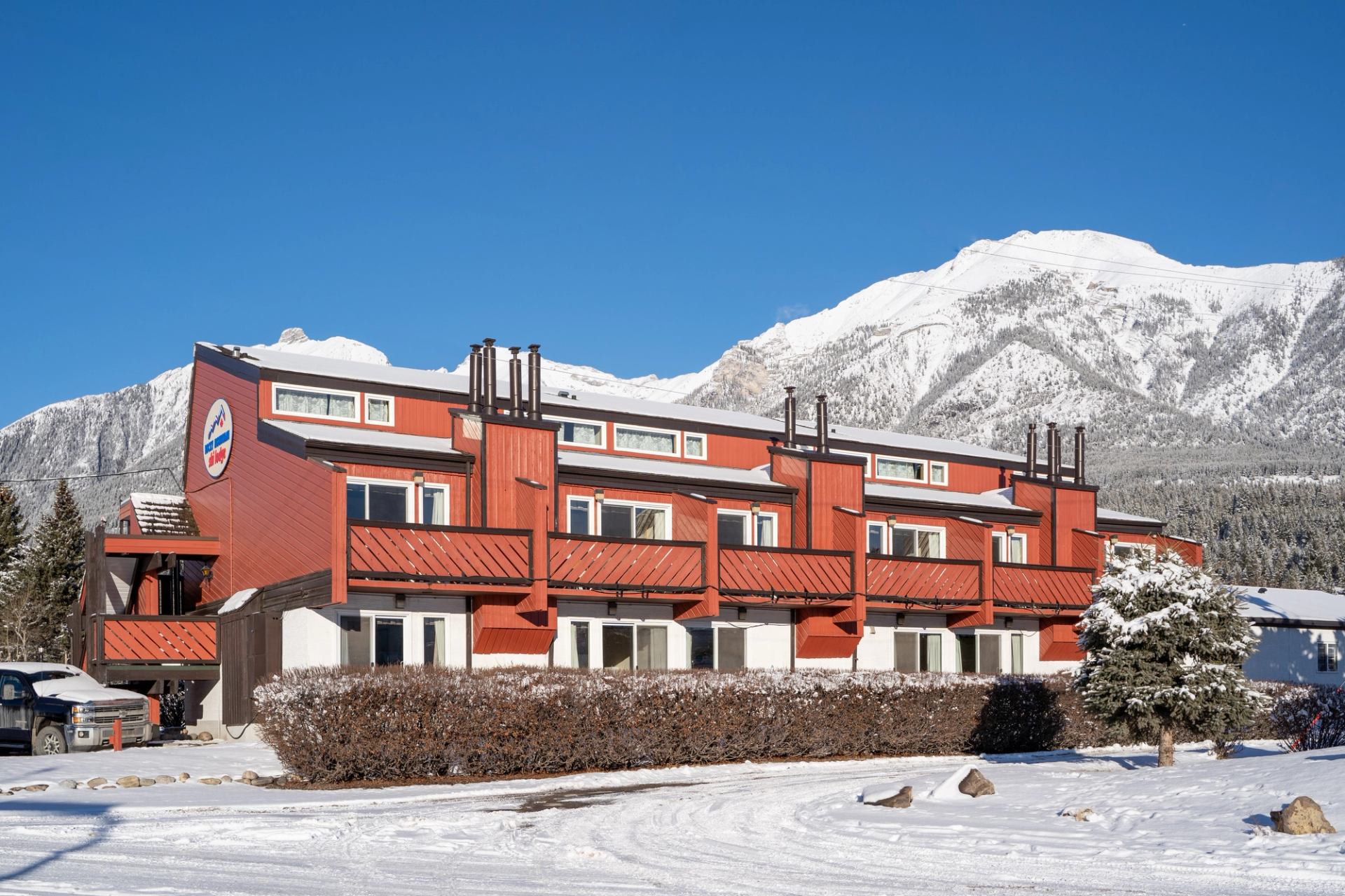 Rocky Mountain Ski Lodge with snowy peaks in the background.