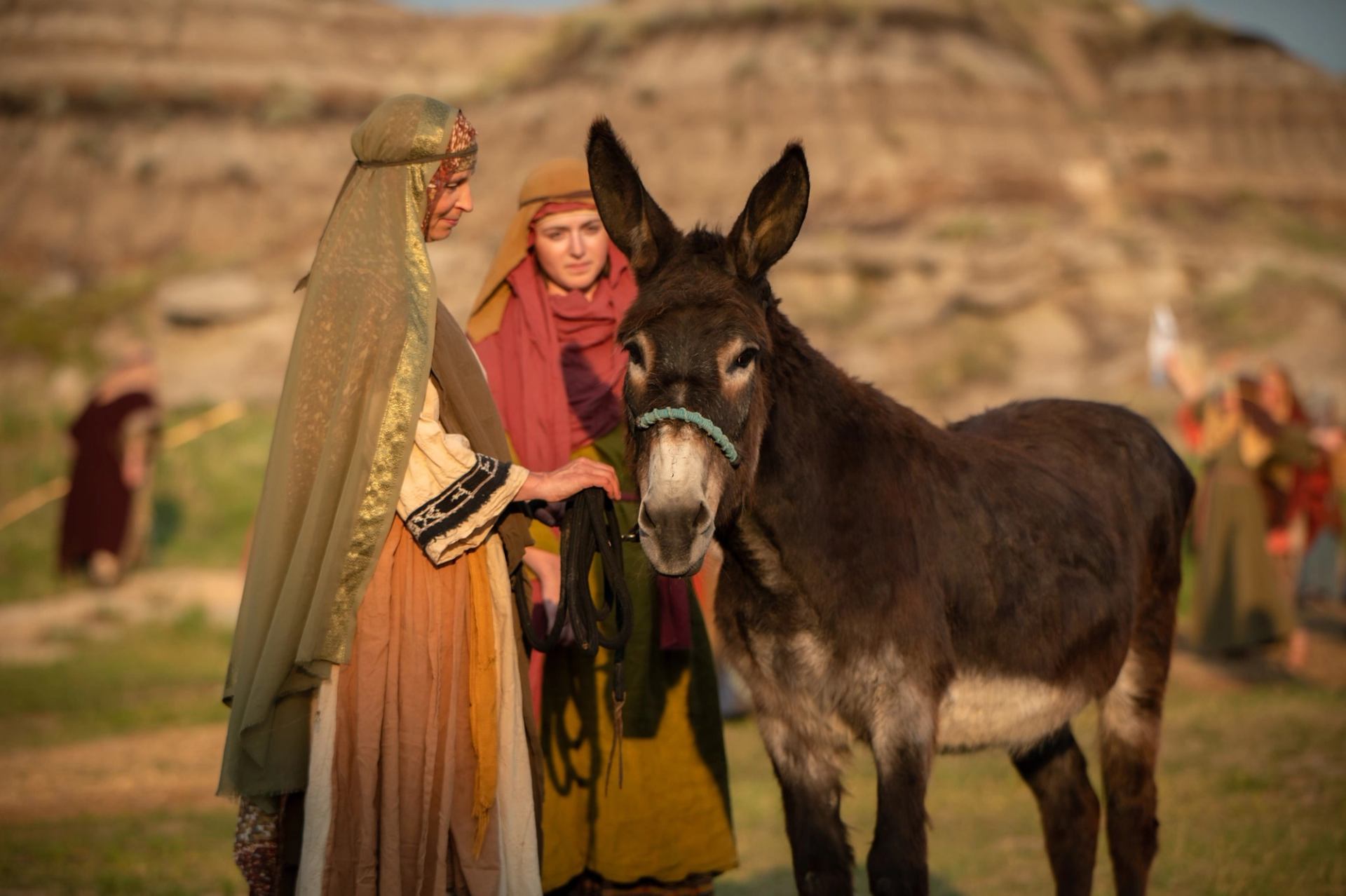 An actor in costume with Sonney, animal donkey actor on stage at the Badlands Passion Play