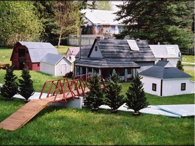 Miniature model of Historic Markerville with buildings, bridge, and greenery.