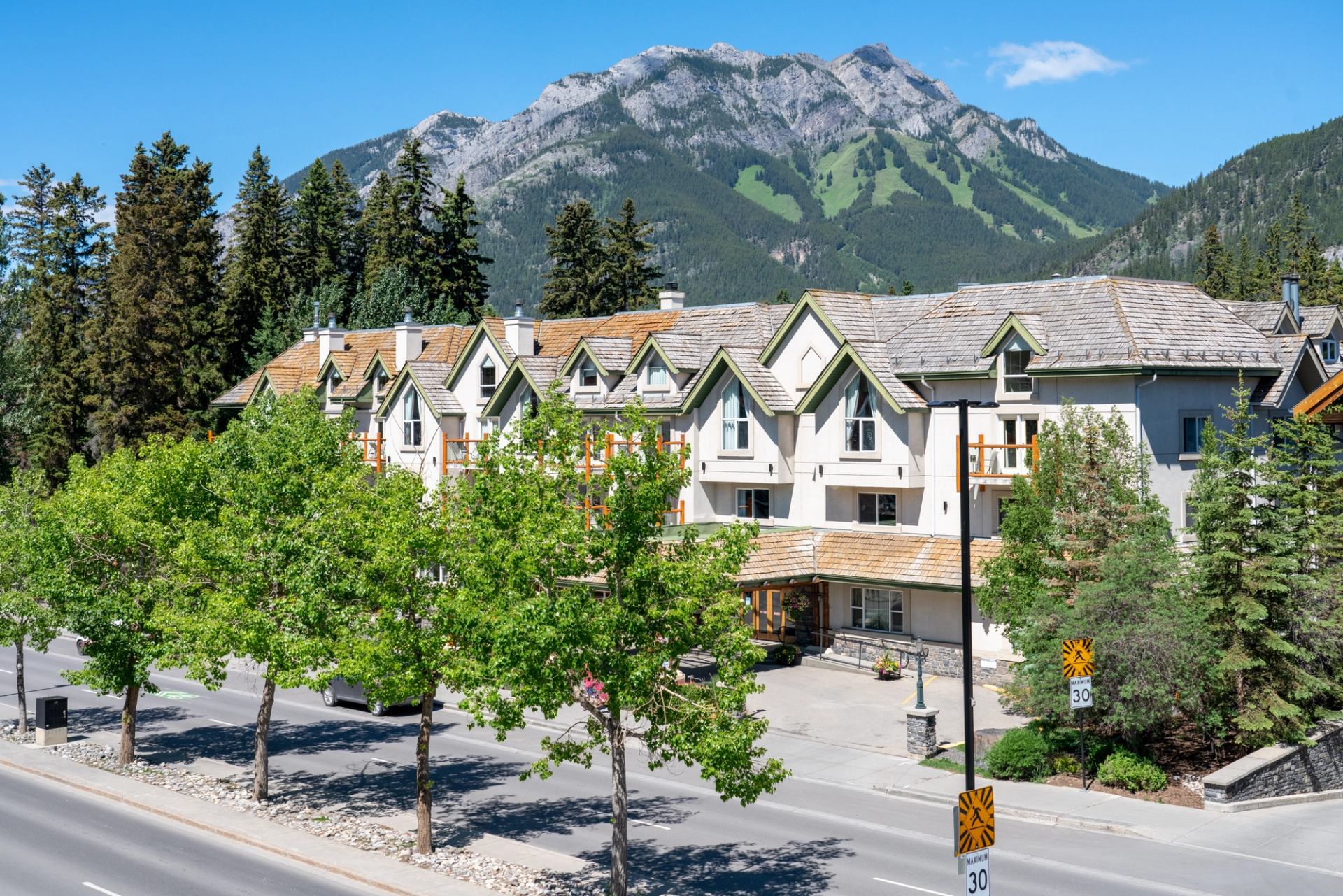 The Rundlestone Lodge with mountain backdrop and rustic architecture.