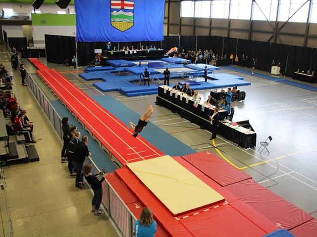 Large gymnasium set up for gymnastics.