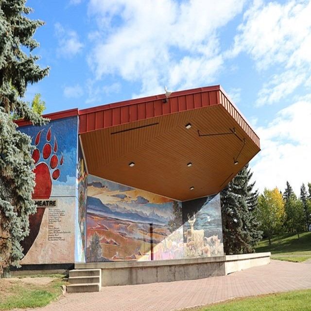 Outdoor stage with roof and painted mural at Muskoseepi Park in Alberta.
