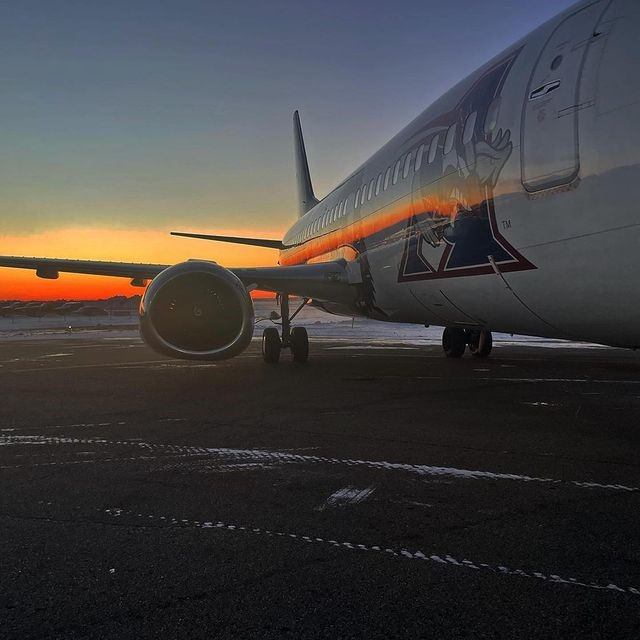 A jet engine with the setting sun in the background.