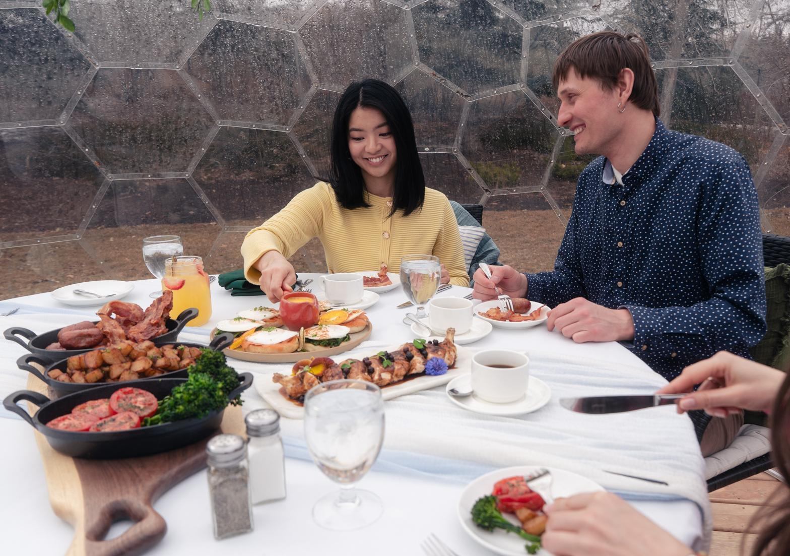 A table filled with brunch plates and drinks as guests share a relaxed meal.