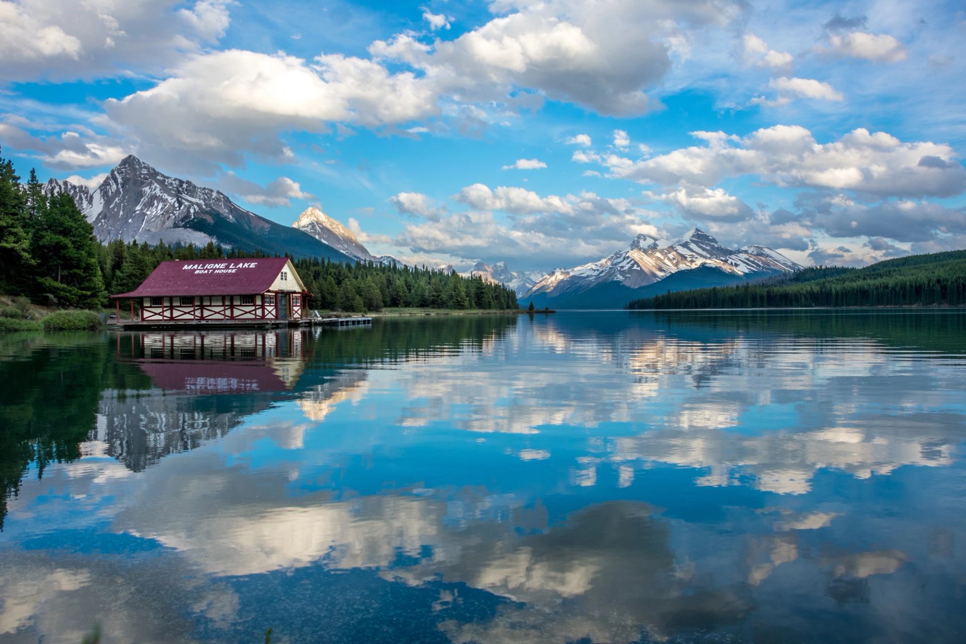 Maligne Lake with the boat house and scenery reflected in the water in Jasper National Park.