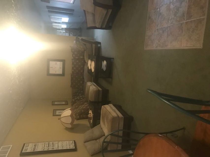 Cabin interior with beds, tiled wall, and window seating with a heater and lamps.