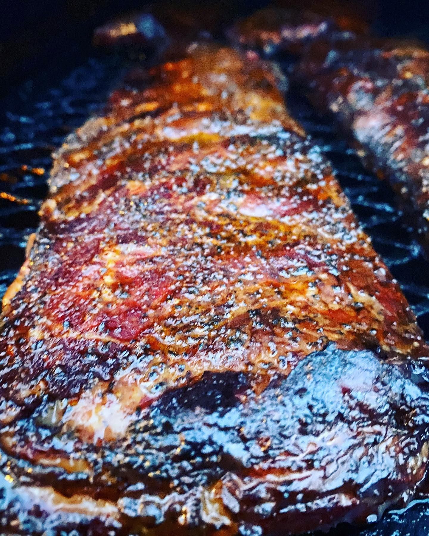 Close-up of tender, glazed smoked ribs with rich seasoning