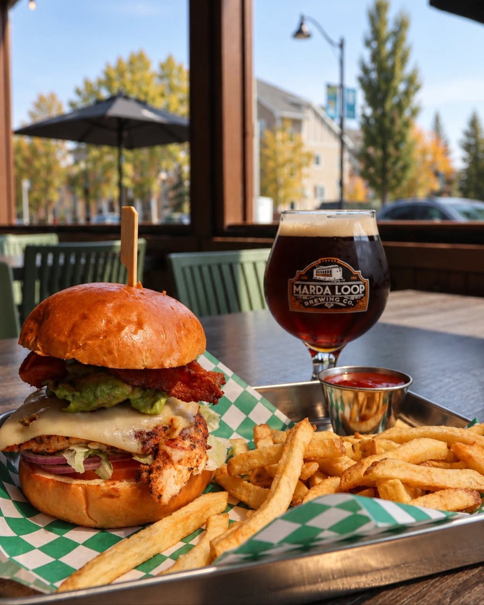 Chicken burger with bacon, avocado, fries and a Marda Loop Brewing Co. beer.