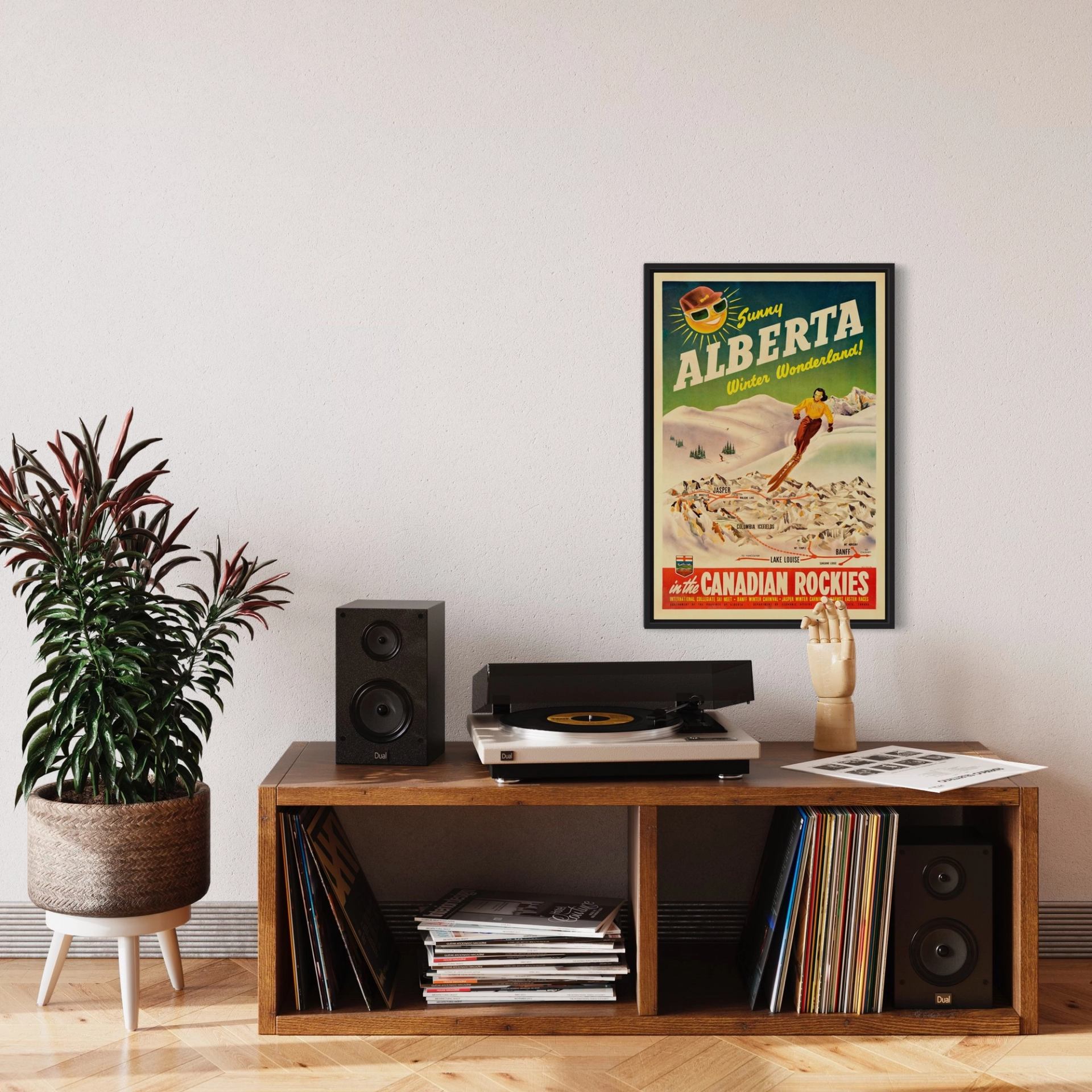 Record player, speakers and vinyl albums sit beneath a framed Alberta poster.