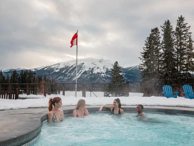 Friends enjoying the hot tub and pool at the Jasper Park Lodge in Jasper National Park