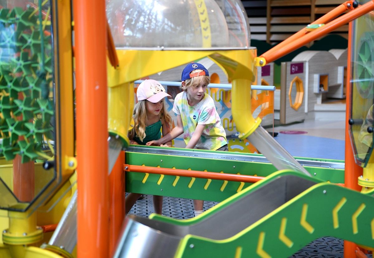 Children playing at a colorful interactive exhibit.