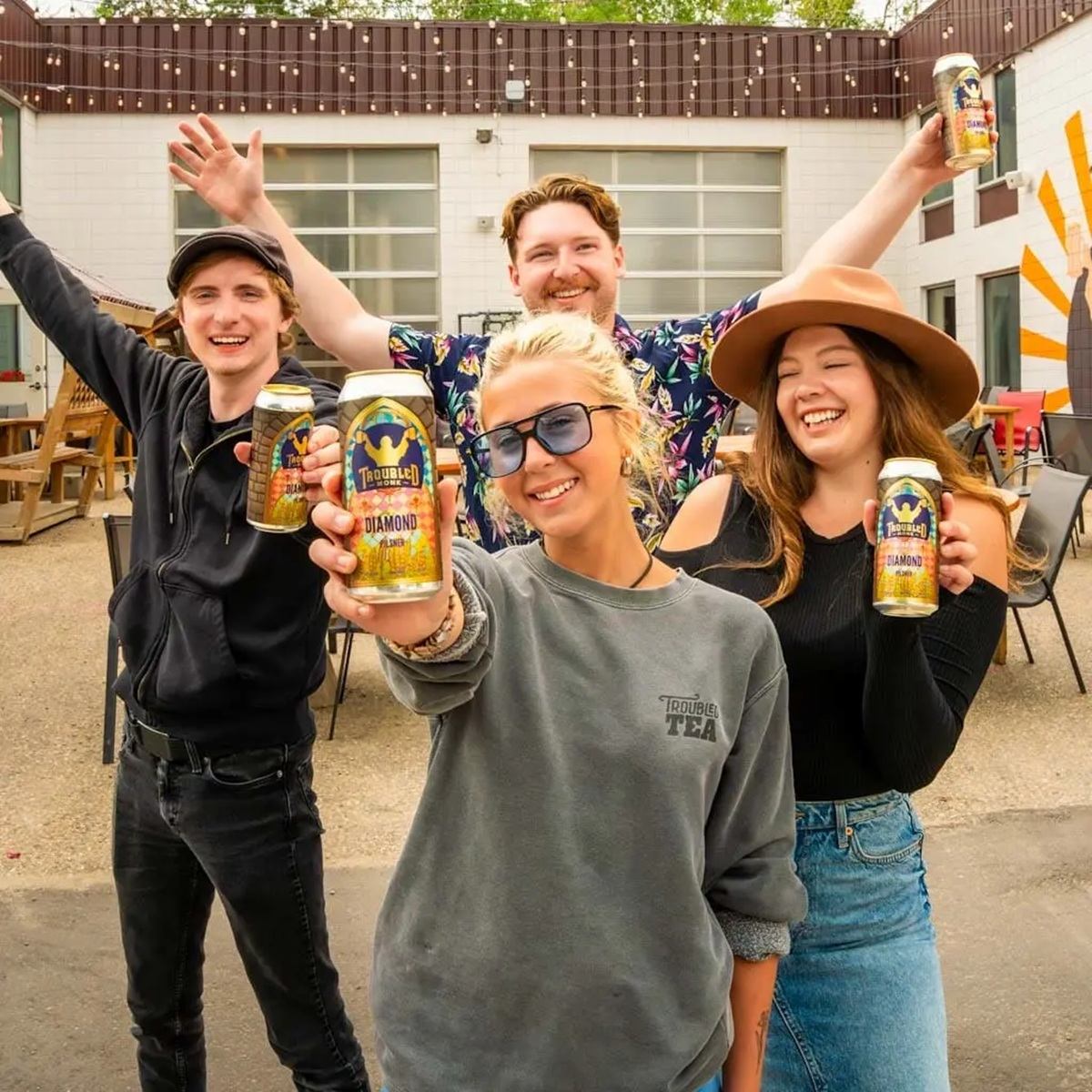 Troubled Monk Brewery showcases visitors enjoying craft beverages in its outdoor gathering space.