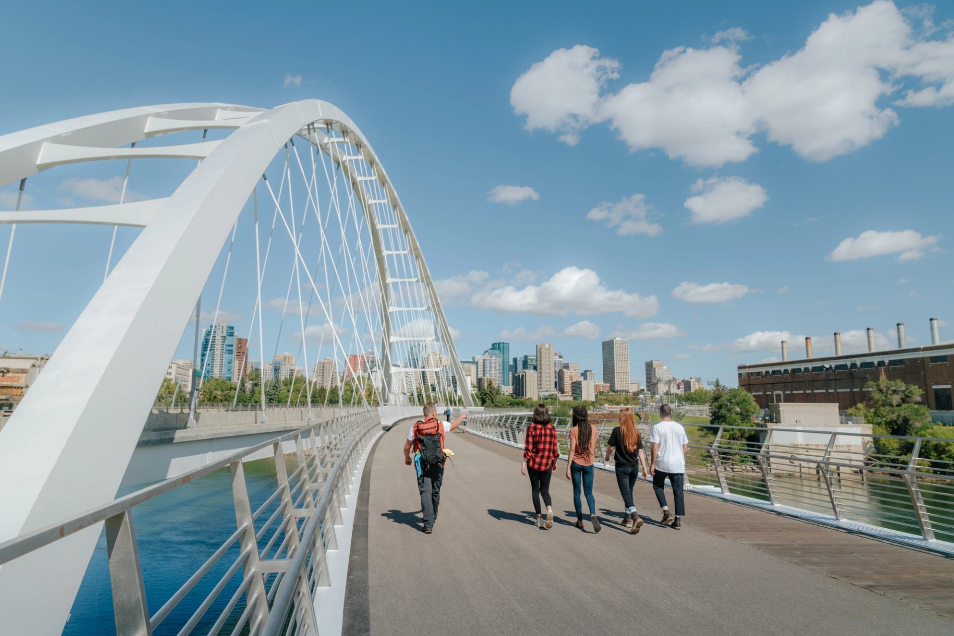 A group of people crossing the Walterdale Bridge.