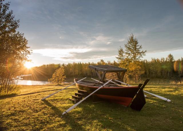 Scenic shot of red canoe on the shore near Rocky Mountain House.