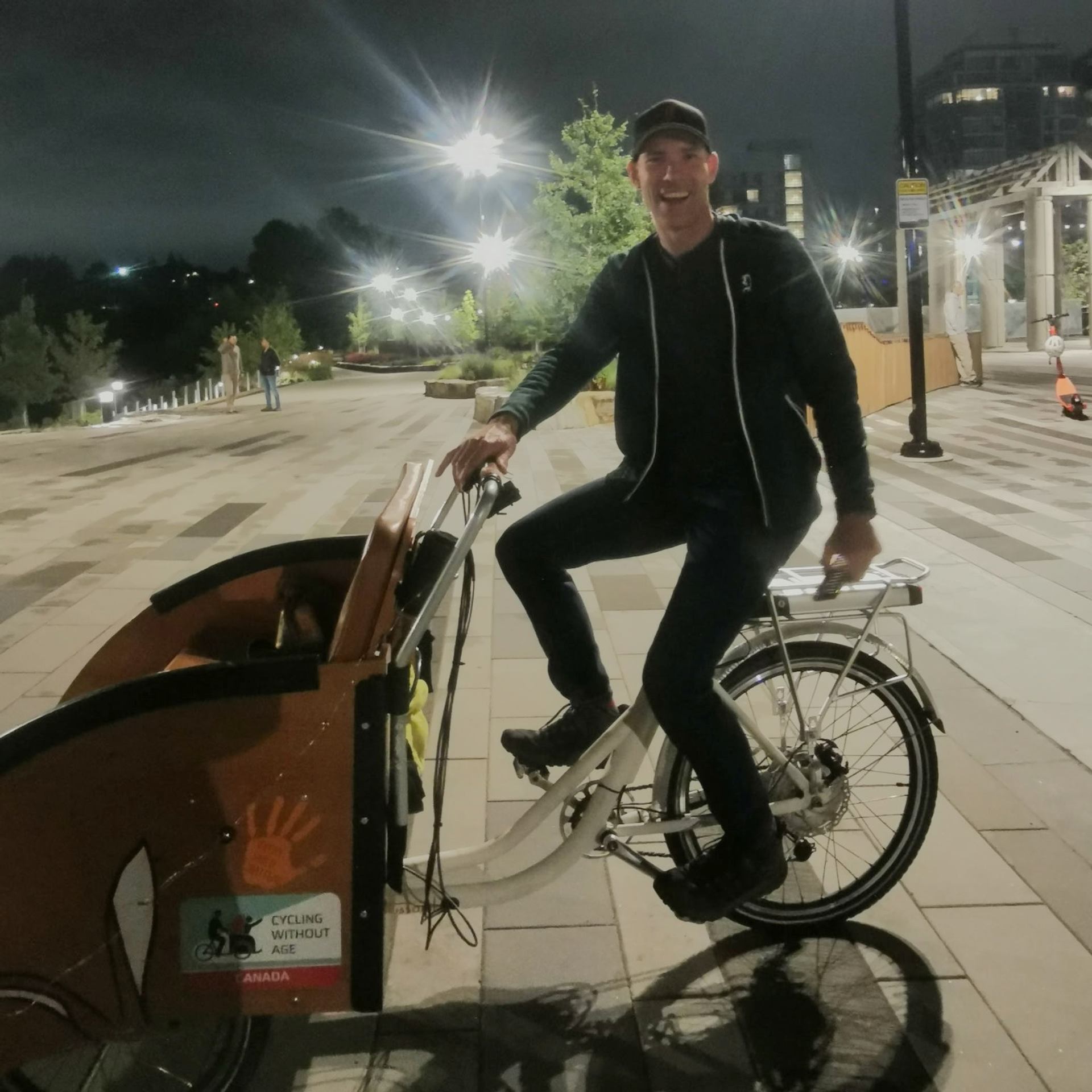 Rider on a Trixie bike cruising through a city at night.