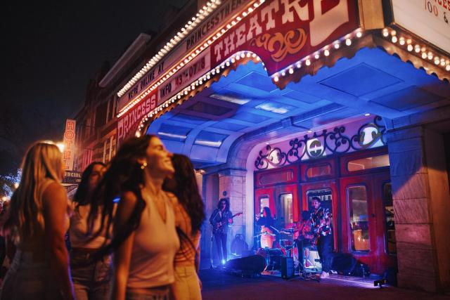 People walking on Whyte Avenue at night.