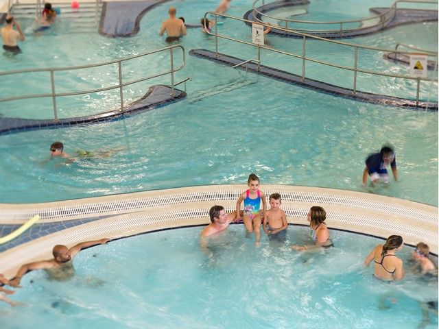 People enjoying the hot tub in the aquatic center.