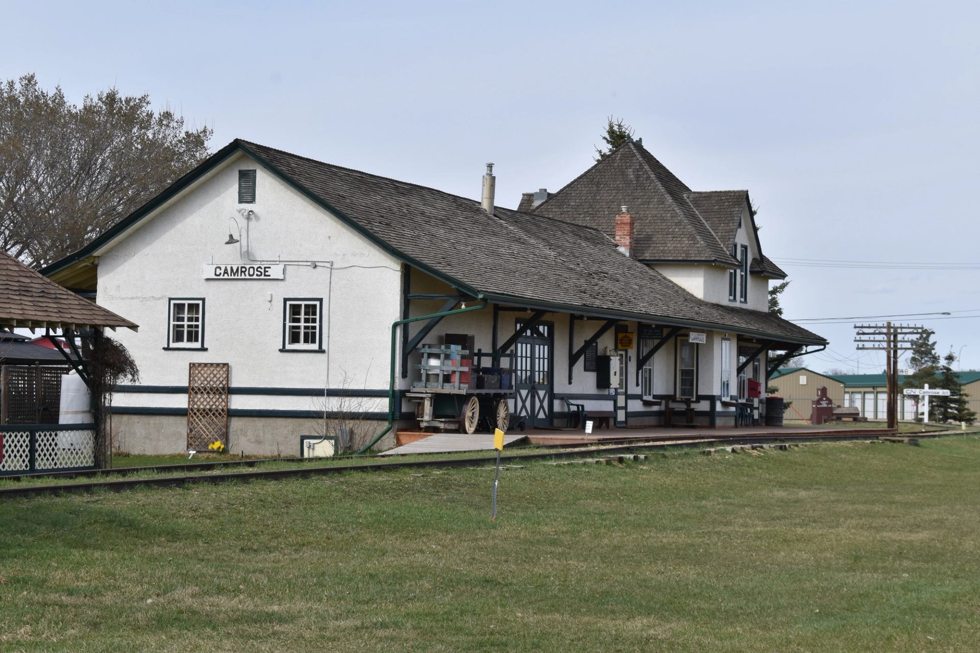 Historic Camrose Heritage Railway Station with wooden platform and green trim.