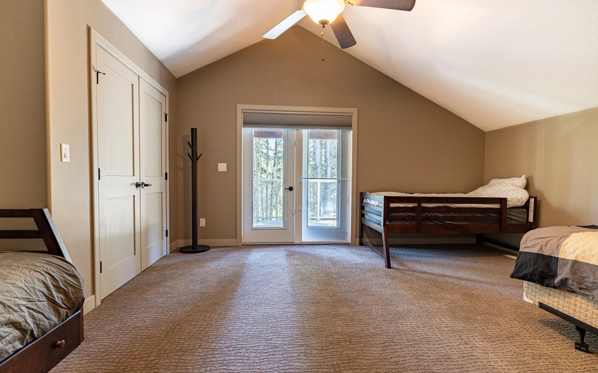 Spacious bedroom with twin beds and outdoor access.