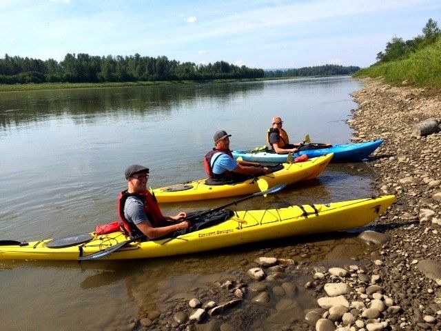 Group of kayakers on the shore of Peace River.